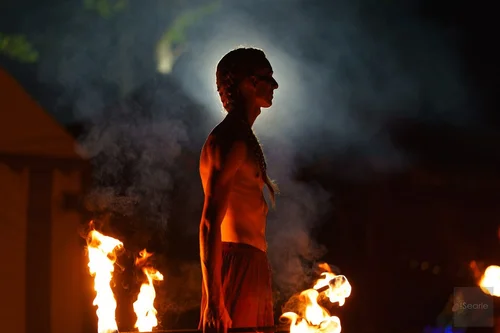 Silhouetted fire dancer between the flames at a Cornwall festival