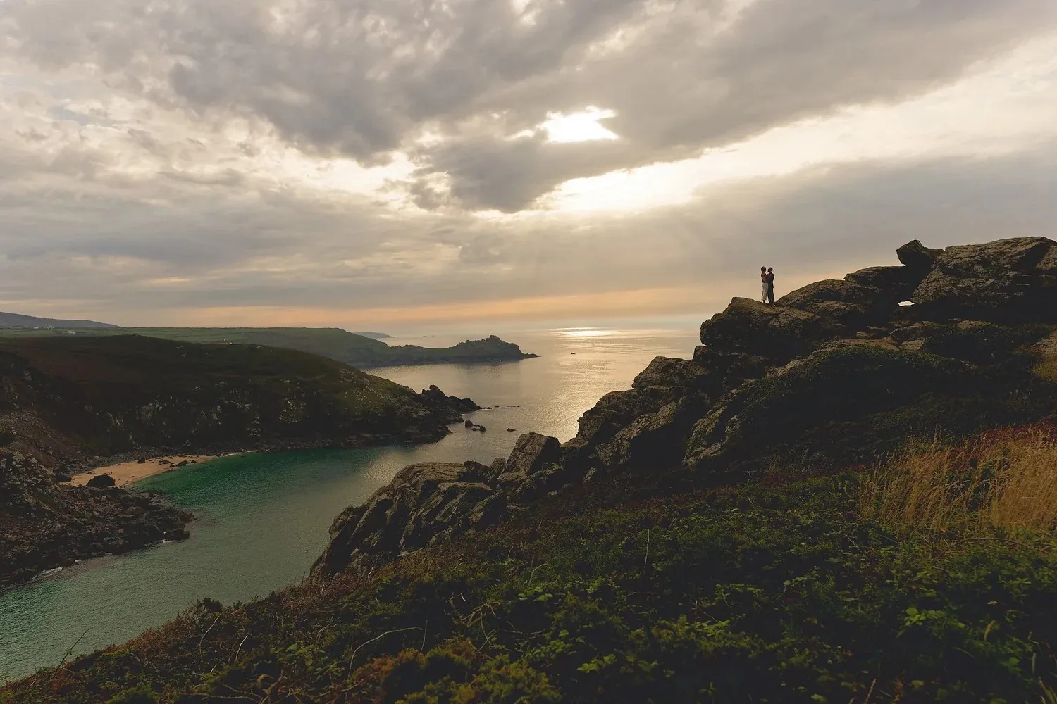 Zennor clifftop wedding at sunset Couple embracing on Zennor clifftops at sunset during a Cornwall wedding