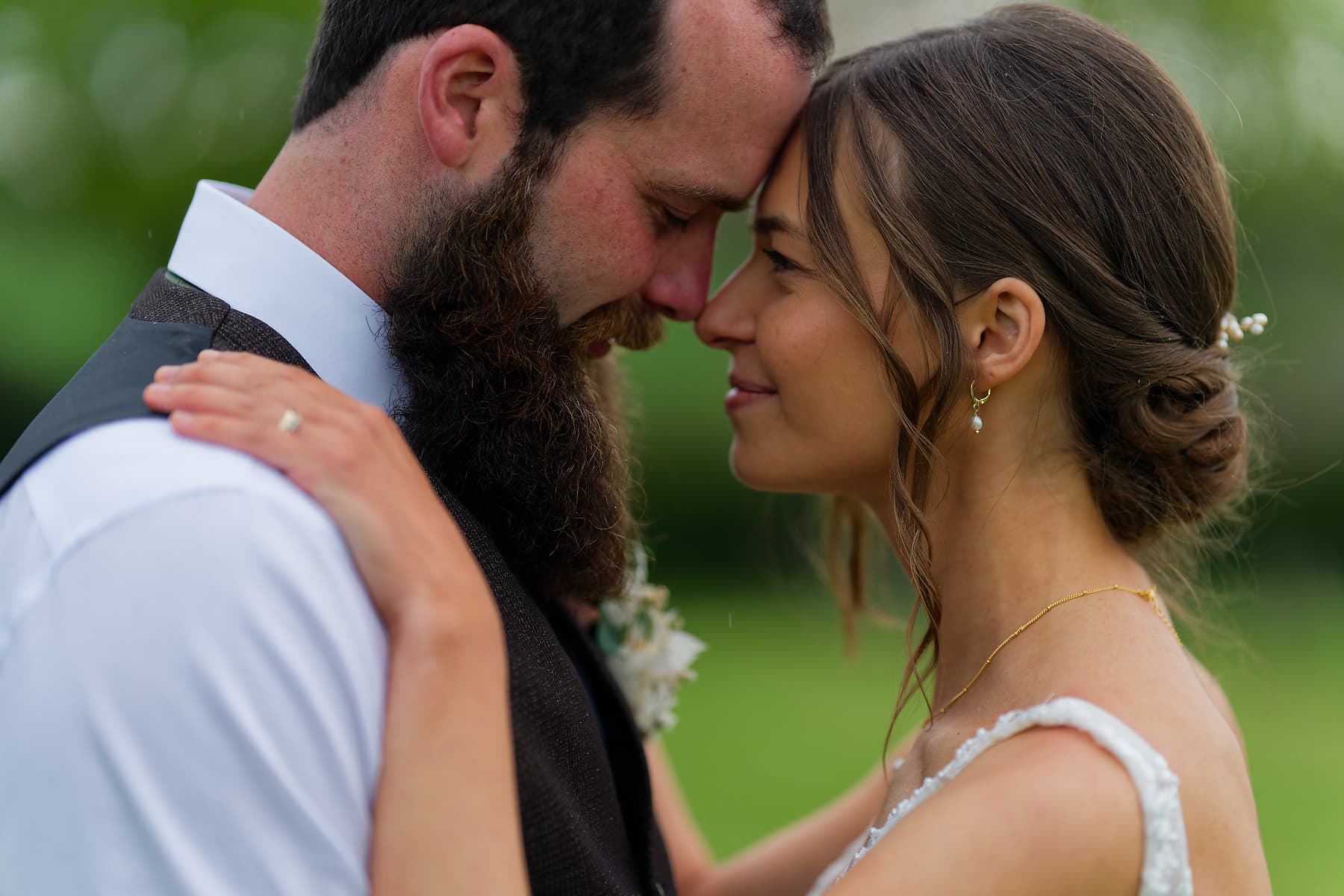 Documentary Cornwall wedding photography: newlyweds sharing a quiet moment in the rain