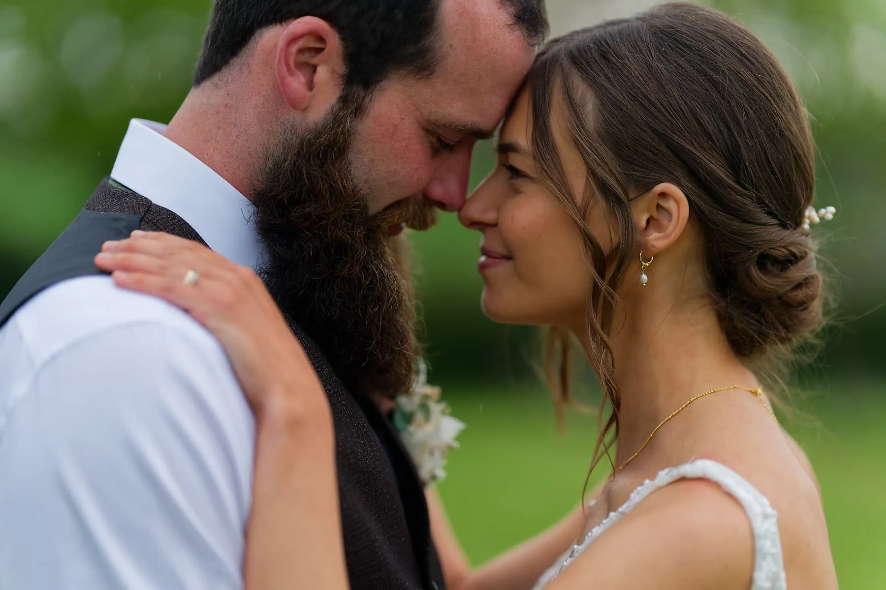 Newlyweds sharing a quiet moment outdoors during their rainy Cornwall wedding